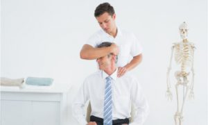 A male having his chiropractic adjustment from a certified chiropractor.